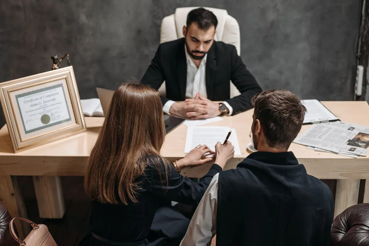 Abogado revisando papeles con clientes en una reunión