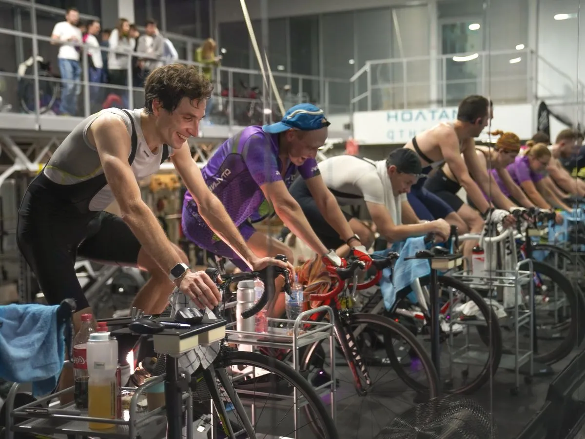 Grupo pedaleando en bicicletas fijas durante una clase de spinning